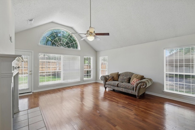 8100 Hosta Way, Fort Worth, TX 76123 - sitting room featuring ceiling fan, hardwood / wood-style floors, a textured ceiling, a fireplace, and high vaulted ceiling