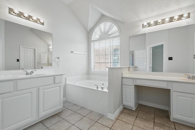 8100 Hosta Way, Fort Worth, TX 76123 - full bath with vaulted ceiling, tile patterned floors, a bath, two vanities, and baseboards