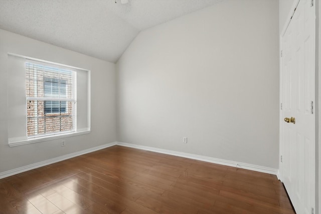 8100 Hosta Way, Fort Worth, TX 76123 - spare room with lofted ceiling, dark wood finished floors, baseboards, and a textured ceiling