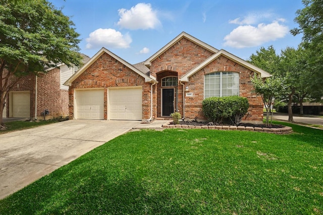 8100 Hosta Way, Fort Worth, TX 76123 - view of front of home featuring a garage, brick siding, a front lawn, and driveway
