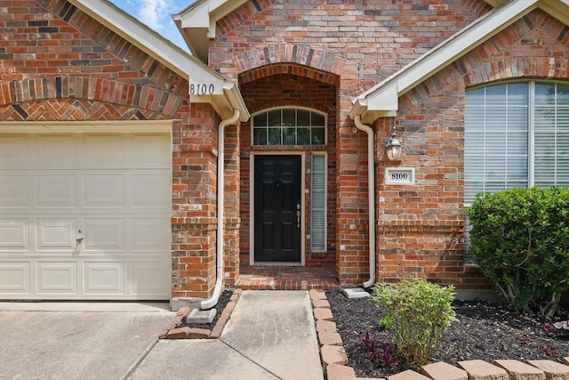8100 Hosta Way, Fort Worth, TX 76123 - entrance to property featuring a garage, brick siding, and concrete driveway