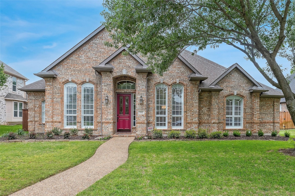 501 Graham Dr, Coppell, TX 75019 - french country home with brick siding, a front lawn, and roof with shingles