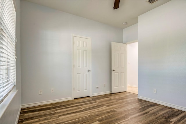 2144 Callahan Dr, Forney, TX 75126 - unfurnished bedroom with wood finished floors, baseboards, and a ceiling fan