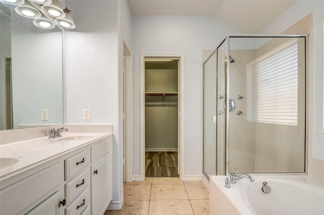 2144 Callahan Dr, Forney, TX 75126 - bathroom featuring a shower stall, tile patterned floors, a bath, a spacious closet, and double vanity