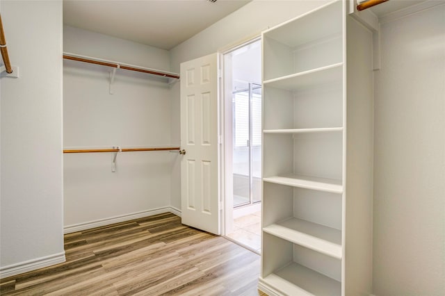 2144 Callahan Dr, Forney, TX 75126 - walk in closet featuring wood finished floors