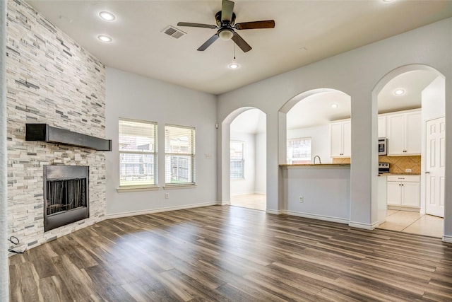 2144 Callahan Dr, Forney, TX 75126 - unfurnished living room with a ceiling fan, wood finished floors, a fireplace, recessed lighting, and baseboards
