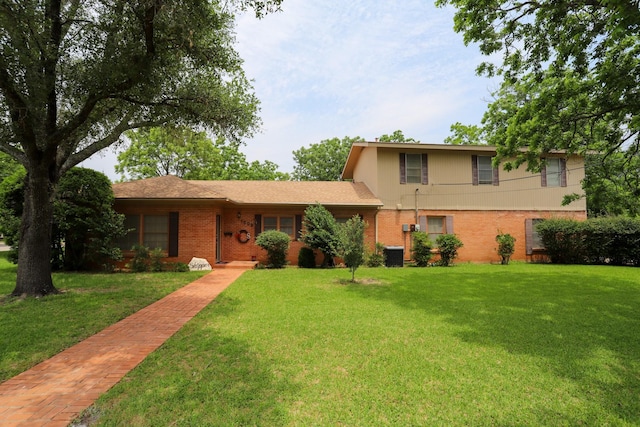 1000 S Harrison St, Mcgregor, TX 76657 - view of front of property with brick siding, a front lawn, and central AC