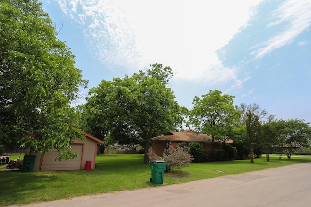 1000 S Harrison St, Mcgregor, TX 76657 - view of grassy yard with a detached garage and an outbuilding