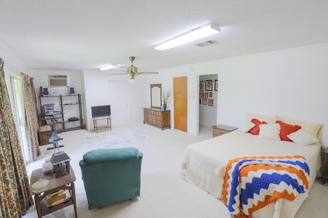 1000 S Harrison St, Mcgregor, TX 76657 - carpeted bedroom featuring ceiling fan and a wall mounted AC