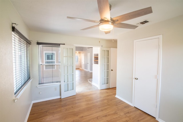 417 Red Coat Ln, Arlington, TX 76002 - spare room featuring ceiling fan, baseboards, french doors, and light wood-style flooring