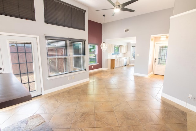 417 Red Coat Ln, Arlington, TX 76002 - spare room with a ceiling fan, a towering ceiling, light tile patterned flooring, and baseboards