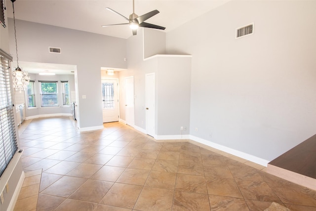 417 Red Coat Ln, Arlington, TX 76002 - unfurnished room with a ceiling fan, high vaulted ceiling, tile patterned flooring, baseboards, and a chandelier
