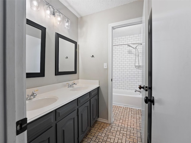 4509 Trowbridge Dr, Arlington, TX 76013 - bathroom featuring a textured ceiling, double vanity, shower / tub combination, and baseboards