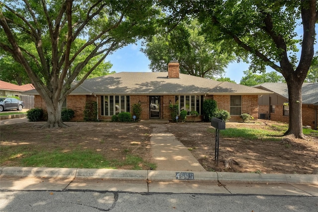 4509 Trowbridge Dr, Arlington, TX 76013 - single story home with brick siding, a chimney, and a shingled roof