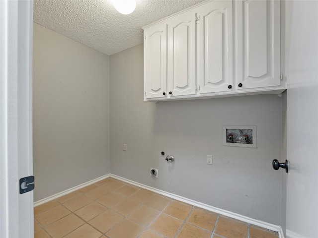 4509 Trowbridge Dr, Arlington, TX 76013 - laundry area with cabinet space, washer hookup, a textured ceiling, light tile patterned flooring, and baseboards