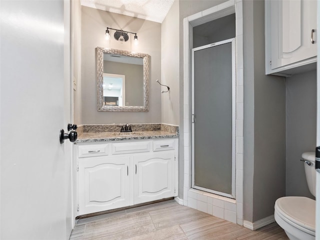 4509 Trowbridge Dr, Arlington, TX 76013 - full bath with toilet, a stall shower, baseboards, wood finished floors, and vanity