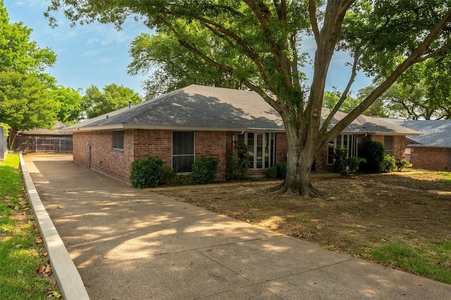 4509 Trowbridge Dr, Arlington, TX 76013 - ranch-style house featuring brick siding, a shingled roof, fence, and concrete driveway