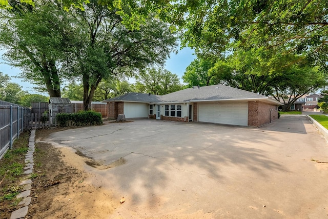 4509 Trowbridge Dr, Arlington, TX 76013 - ranch-style house with brick siding, a garage, fence, and concrete driveway