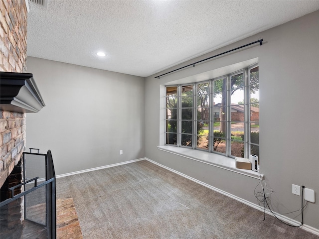 4509 Trowbridge Dr, Arlington, TX 76013 - unfurnished living room featuring carpet flooring, a textured ceiling, baseboards, and a stone fireplace