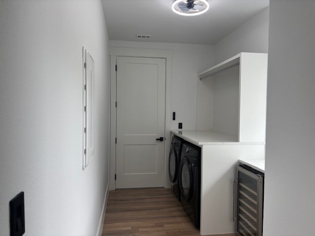 5073 Loper Cir, Streetman, TX 75859 - washroom with washing machine and clothes dryer, wine cooler, wood finished floors, and baseboards
