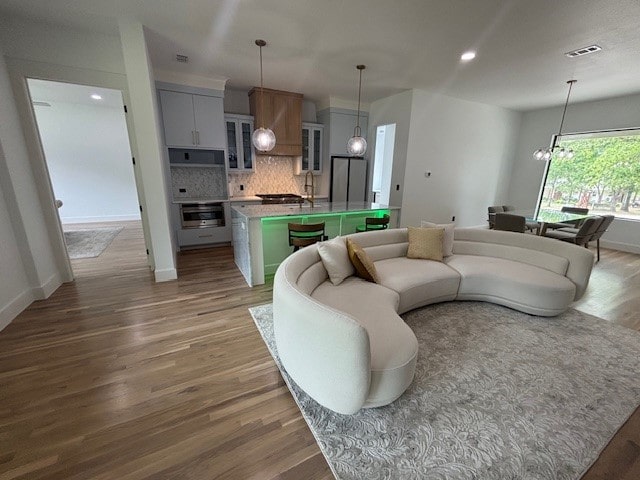 5073 Loper Cir, Streetman, TX 75859 - living room featuring wood finished floors, a chandelier, baseboards, and recessed lighting
