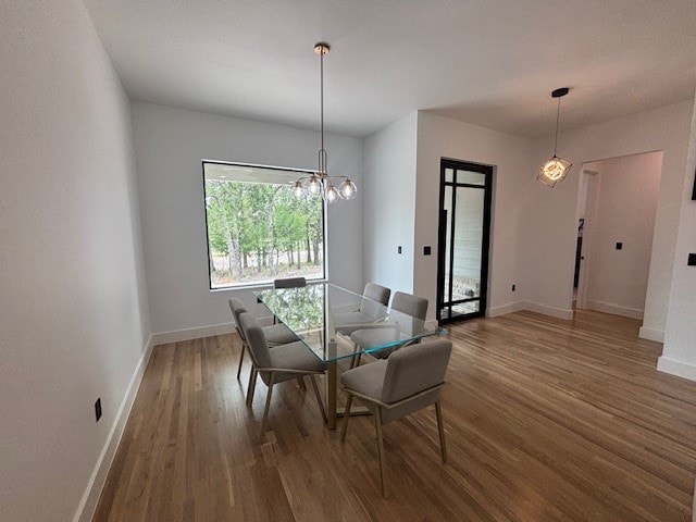 5073 Loper Cir, Streetman, TX 75859 - dining space featuring wood finished floors, baseboards, and a chandelier