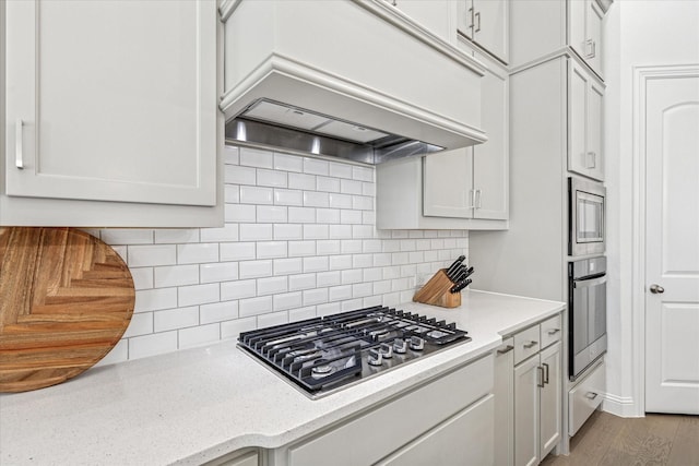 806 Placid Way, Argyle, TX 76226 - kitchen with stainless steel appliances, custom range hood, backsplash, wood finished floors, and light stone counters