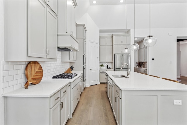 806 Placid Way, Argyle, TX 76226 - kitchen featuring a sink, stainless steel built in refrigerator, gas cooktop, an island with sink, and light wood-type flooring