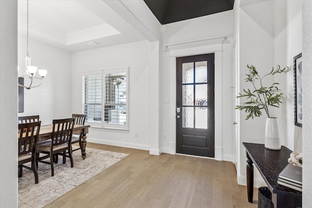 806 Placid Way, Argyle, TX 76226 - entrance foyer featuring a chandelier, wood finished floors, a raised ceiling, and baseboards