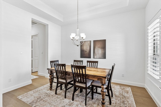 806 Placid Way, Argyle, TX 76226 - dining room with wood finished floors, a chandelier, a tray ceiling, ornamental molding, and baseboards