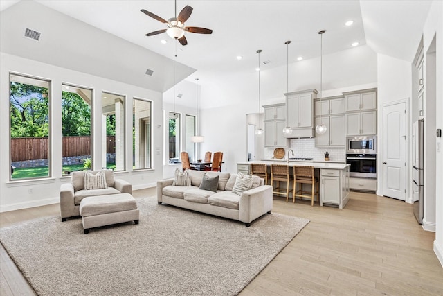 806 Placid Way, Argyle, TX 76226 - living room with plenty of natural light, ceiling fan, light wood-style floors, high vaulted ceiling, and recessed lighting