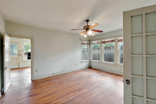 1022 N Edgefield Ave, Dallas, TX 75208 - spare room with a ceiling fan, wood finished floors, healthy amount of natural light, and baseboards