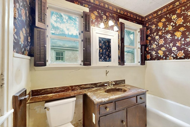1022 N Edgefield Ave, Dallas, TX 75208 - full bathroom featuring toilet, wallpapered walls, a bath, vanity, and wainscoting