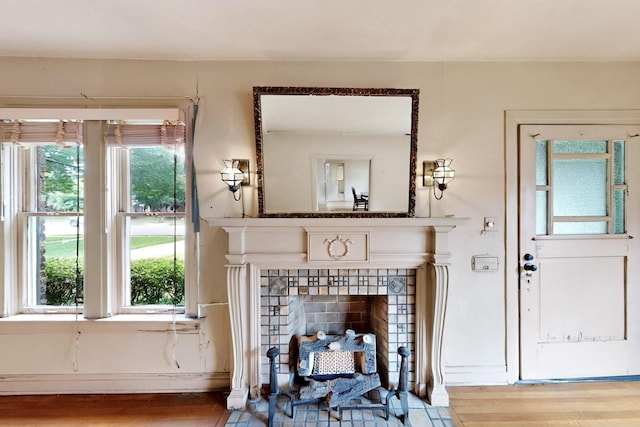 1022 N Edgefield Ave, Dallas, TX 75208 - living area with wood finished floors, baseboards, and a tile fireplace