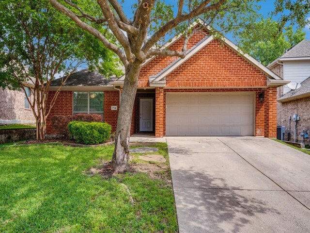 712 Hardwood Dr, Mckinney, TX 75069 - view of front of home with brick siding, a garage, concrete driveway, and a front yard