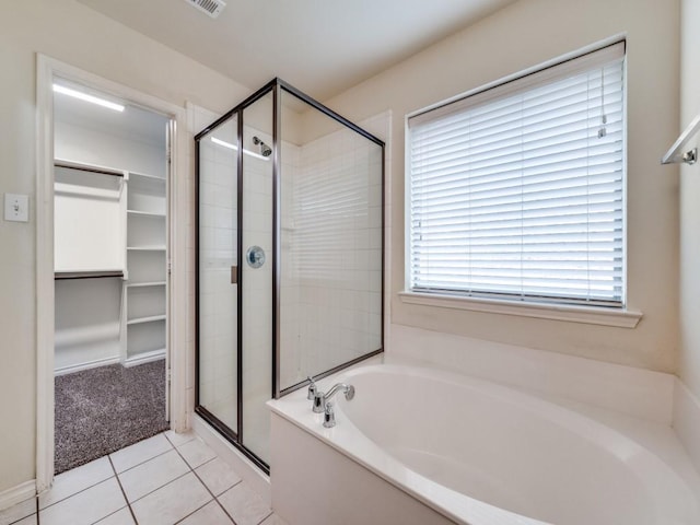 712 Hardwood Dr, Mckinney, TX 75069 - bathroom featuring a stall shower, a garden tub, tile patterned flooring, and a spacious closet