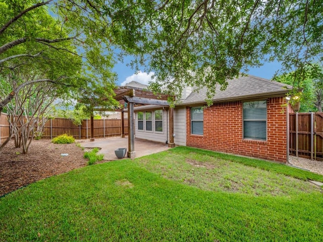 712 Hardwood Dr, Mckinney, TX 75069 - back of house featuring a patio area, brick siding, and roof with shingles