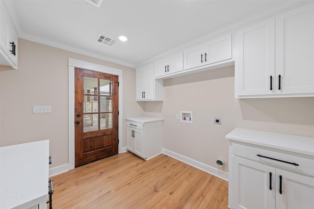 6701 Fish Pond Rd, Waco, TX 76710 - laundry area featuring washer hookup, hookup for an electric dryer, light wood-style flooring, cabinet space, and baseboards