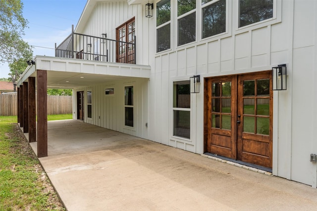 6701 Fish Pond Rd, Waco, TX 76710 - entrance to property with board and batten siding, french doors, a balcony, fence, and a patio