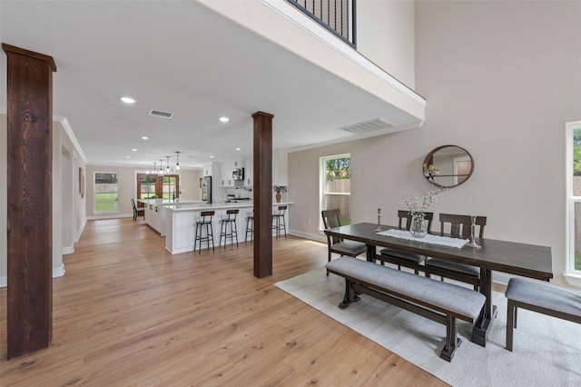 6701 Fish Pond Rd, Waco, TX 76710 - dining room with light wood-type flooring, baseboards, crown molding, recessed lighting, and decorative columns