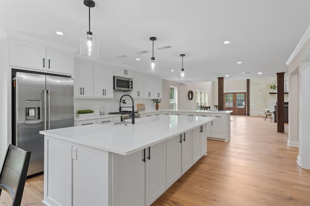 6701 Fish Pond Rd, Waco, TX 76710 - kitchen with high end appliances, light wood-style floors, a peninsula, light countertops, and recessed lighting