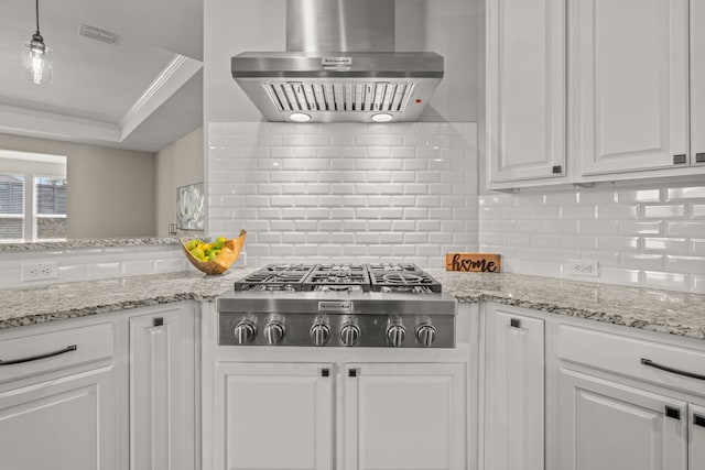712 Freedom Ln, Little Elm, TX 76227 - kitchen featuring wall chimney range hood, stainless steel gas cooktop, ornamental molding, white cabinetry, and tasteful backsplash