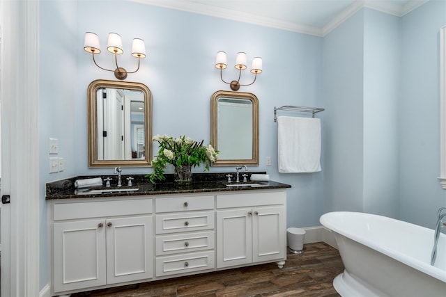 812 Baker St, Mckinney, TX 75069 - full bathroom featuring double vanity, a freestanding bath, wood finished floors, and ornamental molding