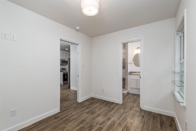 812 Baker St, Mckinney, TX 75069 - unfurnished bedroom featuring dark wood-type flooring and connected bathroom