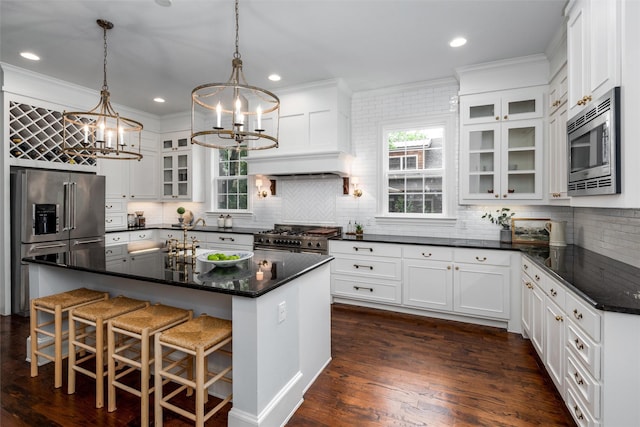 812 Baker St, Mckinney, TX 75069 - kitchen featuring high end appliances, a chandelier, backsplash, white cabinetry, and ornamental molding