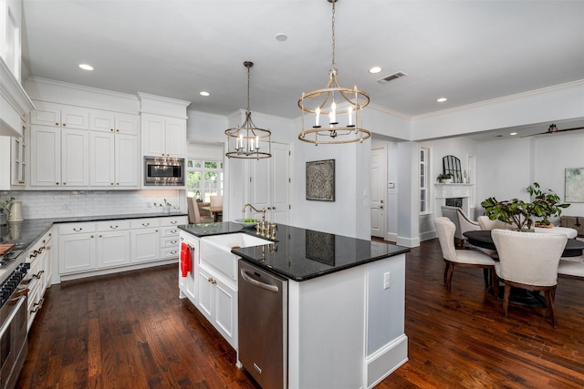 812 Baker St, Mckinney, TX 75069 - kitchen with stainless steel appliances, a chandelier, ornamental molding, dark wood-type flooring, and white cabinetry