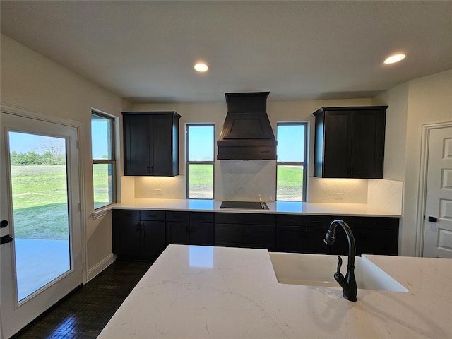 320 Magnolia Ct, Trenton, TX 75490 - kitchen featuring black electric cooktop, custom exhaust hood, recessed lighting, backsplash, and dark wood-style flooring