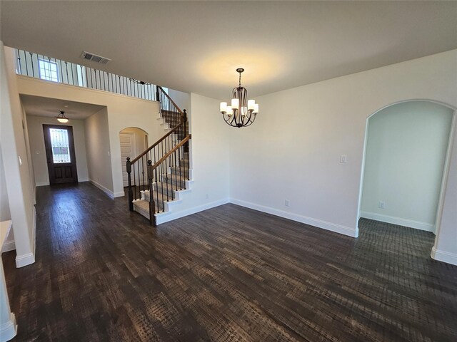 320 Magnolia Ct, Trenton, TX 75490 - entryway with arched walkways, stairway, dark wood-type flooring, a chandelier, and baseboards
