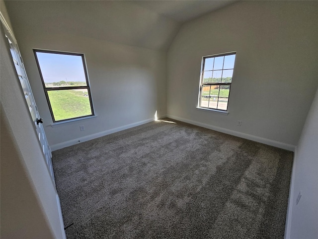 320 Magnolia Ct, Trenton, TX 75490 - spare room featuring lofted ceiling, dark colored carpet, and baseboards