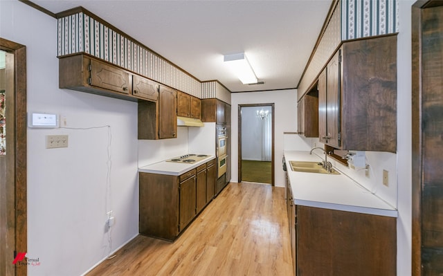 5023 Dedman Dr, Shreveport, LA 71107 - kitchen featuring light wood finished floors, a sink, light countertops, white electric cooktop, and crown molding